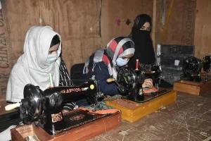 Women learning tailing skills through JKHCA's Empowerment Program